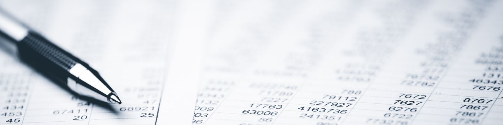 A picture of a pen on a financial spreadsheet