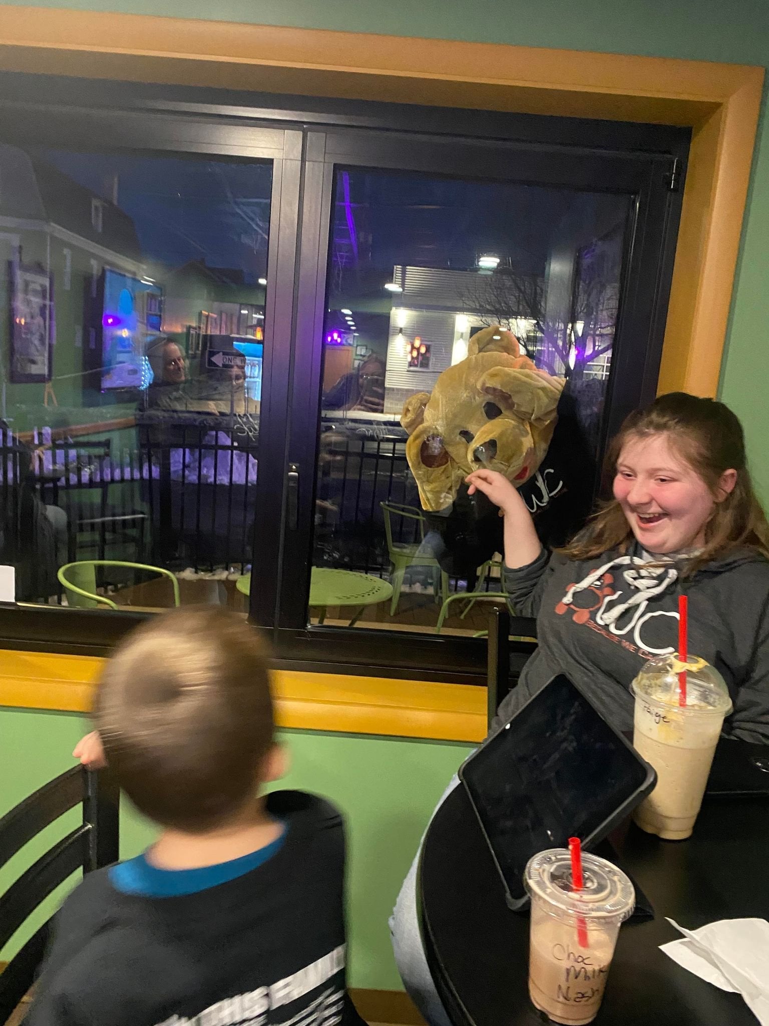 BWC mascott looking through a window from the outside at kids.