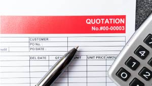 A pen and calculator laying on top of a bid document