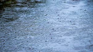A picture of standing water on top of a road during a rain storm.